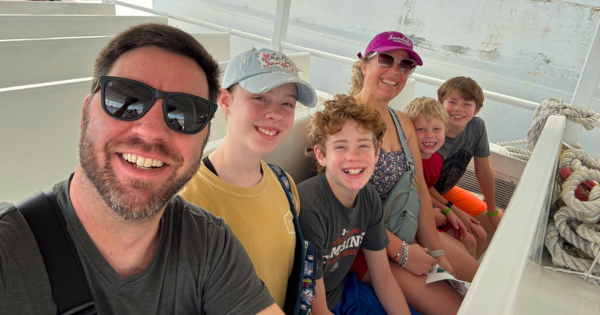 Picture of Joy Oufnac and her family riding in a boat.