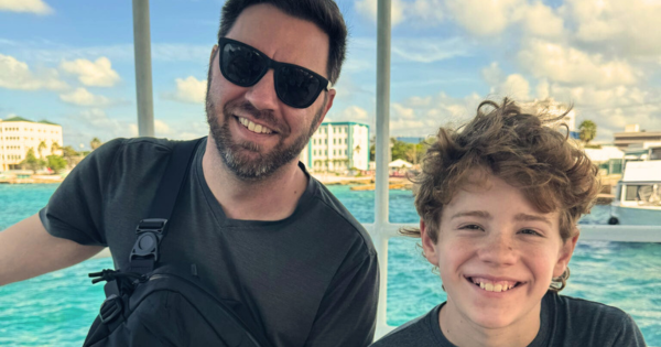 Picture of Jonathan Oufnac and his son on a boat.