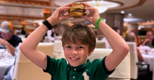 Picture of Joy Oufnac's little son enjoying a hamburger on a family Cruise.