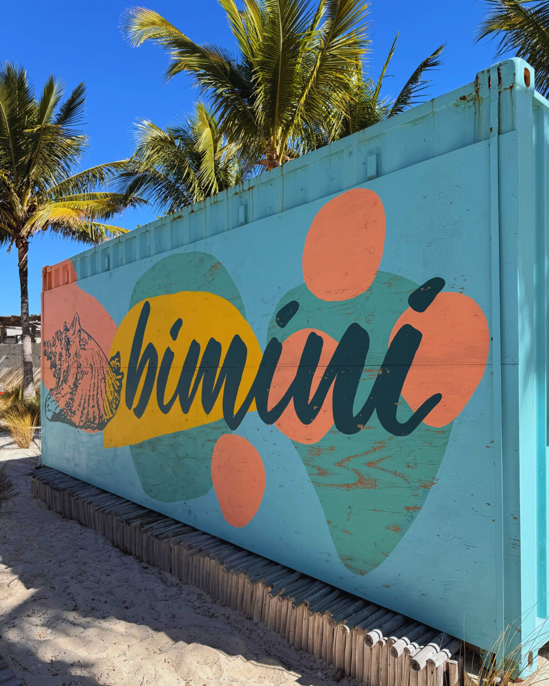 Picture of Colorful wall with the word "Bimini" painted on it.